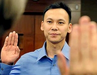 LOS ANGELES, CALIFORNIA SEPTEMBER 5, 2011-Olympic badminton hopeful Tony Gunawan raises his right hand as a judge swears him in as a U.S. citizen at the Royball Federal Courthouse in Downtown Los Angeles Times. (Wally Skalij/Los Angeles Times)